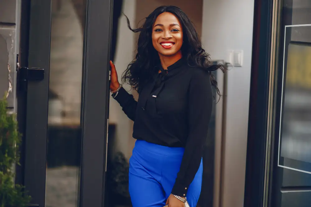 Confident woman smiling in a doorway