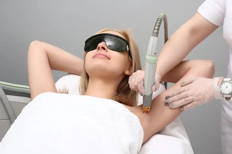 Woman receiving underarm laser hair removal