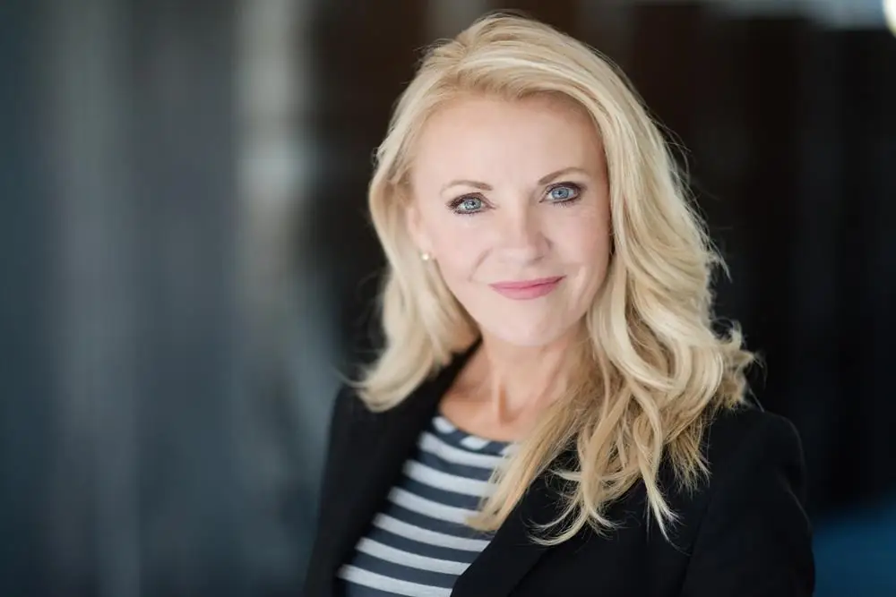Confident blonde woman in a blazer