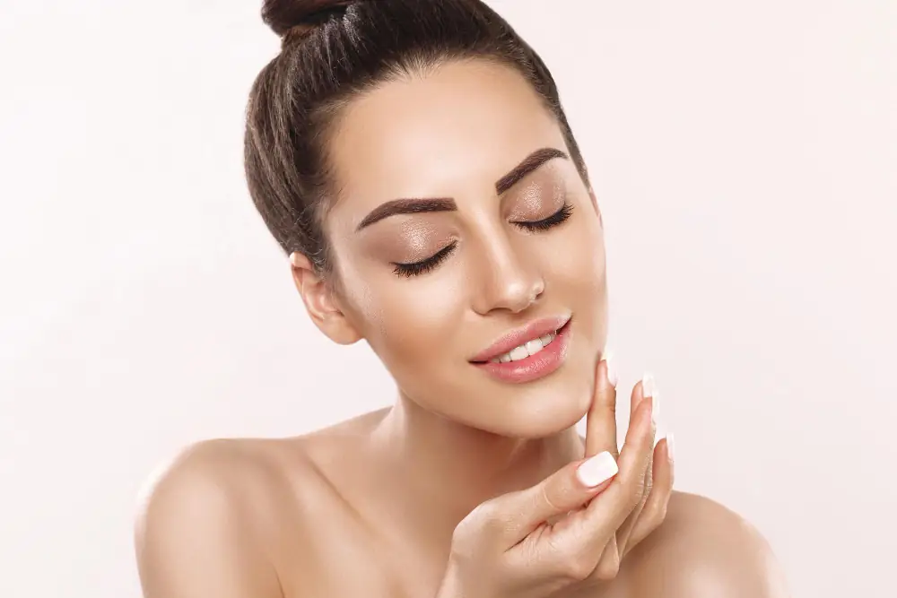 Woman with smooth skin touching her face