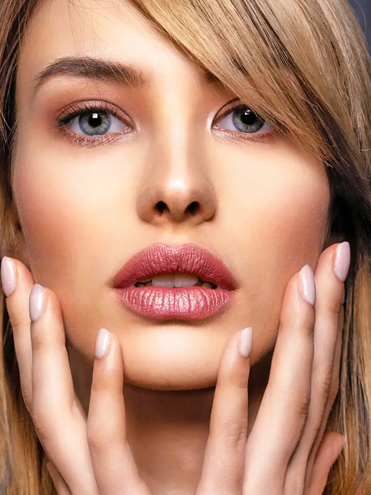 Woman with clear, beautiful skin touching her face